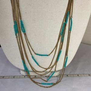 Long multi strand necklace with tiny blue bead stations